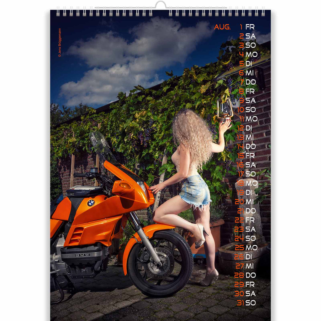 Blonde Sits on Orange Bike in Nude Motorcycle Calendar