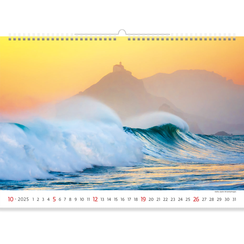 Elegance and grace are captured on the page of Sea Calendar 2025. A wave, amazing in its strength and beauty, cuts through the sea against the backdrop of the setting sun. A lonely house can be seen in the distance.