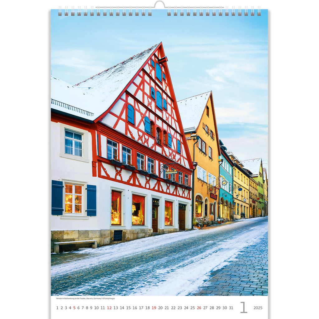 In January, the calendar features a quaint, snow-kissed street, capturing the serene beauty of winter. Laden with glistening snowflakes, cozy houses, and twinkling lights, it invites a moment of tranquility and nostalgia, celebrating the charm of the season in a picturesque setting.