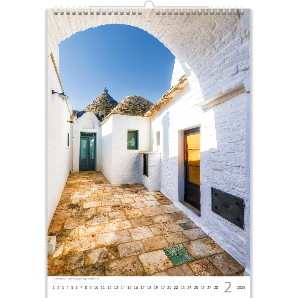 The 2025 calendar showcases an arched gateway opening to a sunlit lane adorned with white trulli houses. Bathed in sunlight, these unique, cone-shaped structures stand out against the azure sky, embodying the enchanting beauty of Italy's Alberobello. It's a scene that evokes warmth, history, and Mediterranean allure.