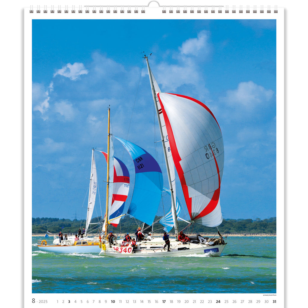 The Sailing Calendar 2025 features yachts racing with spinnakers aloft, showcasing the exhilarating sport of sailing. This dynamic scene captures the beauty of wind-powered vessels in action, their colorful spinnakers billowing against the backdrop of open seas, inviting enthusiasts to immerse themselves in the excitement of competitive sailing adventures.